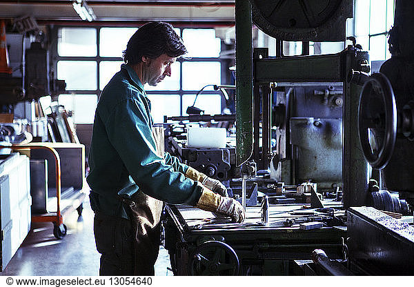 Side view of man working in workshop