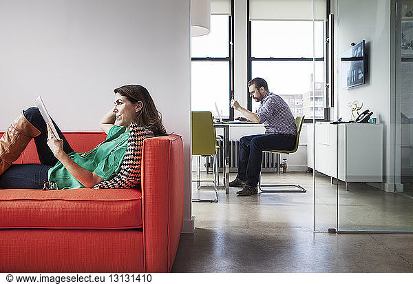 Side view of mature business people working in creative office