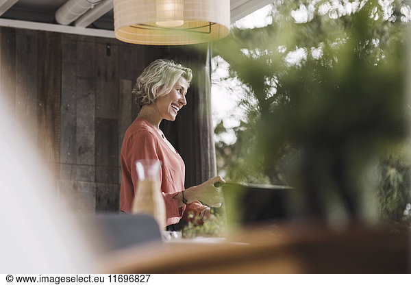 Side view of mid adult businesswoman smiling in portable office truck