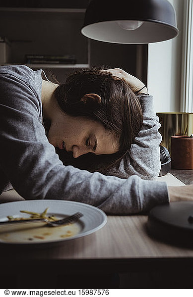 Side view of sad woman at table