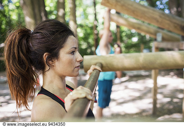 Side view of woman exercising at outdoor gym