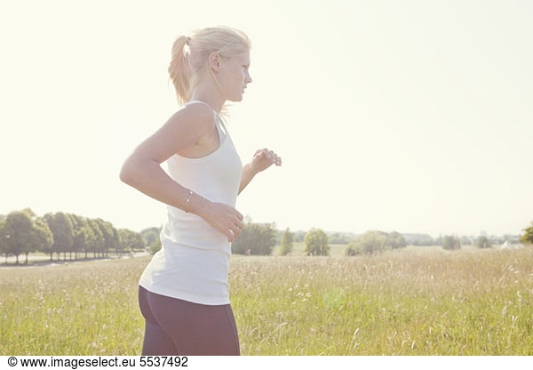 Side view of young woman jogging