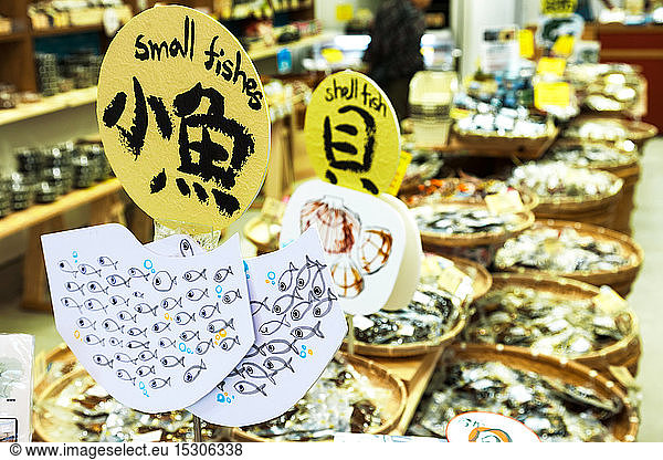 Signs advertising fish and shellfish in a market  Tokyo  Japan.