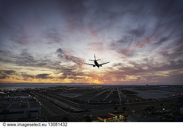 Silhouette airplane landing at airport