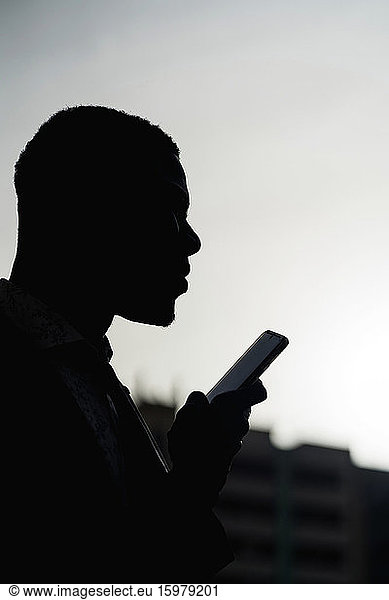 Silhouette of businessman with mobile phone