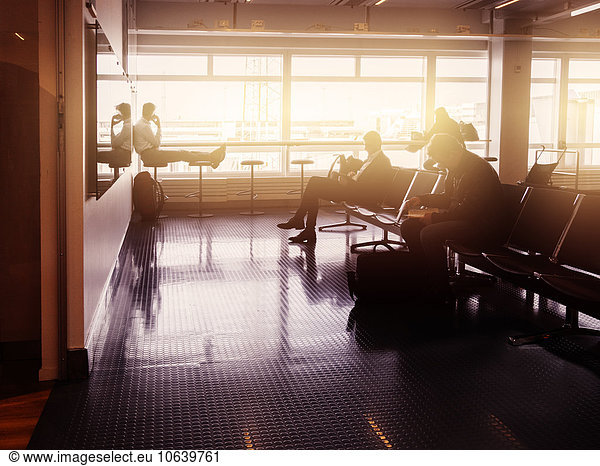 Silhouette of businessmen waiting at airport