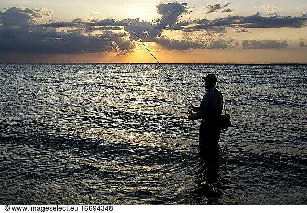 Silhouette of Fisherman fishing in Cape Cod Bay  in Wellfleet  MA