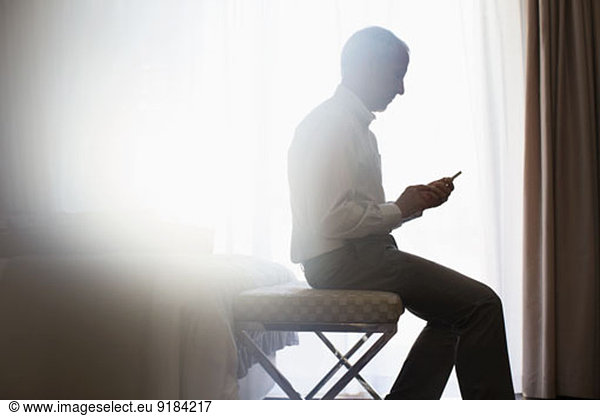 Silhouette of man using cell phone