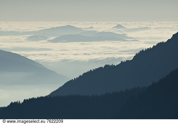 Silhouette of mountainside with clouds