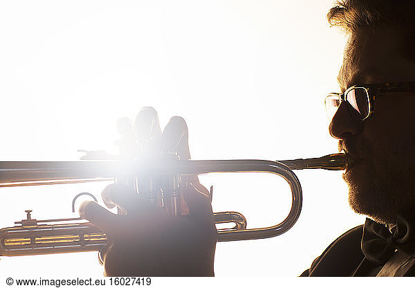 Silhouette of trumpeter performing