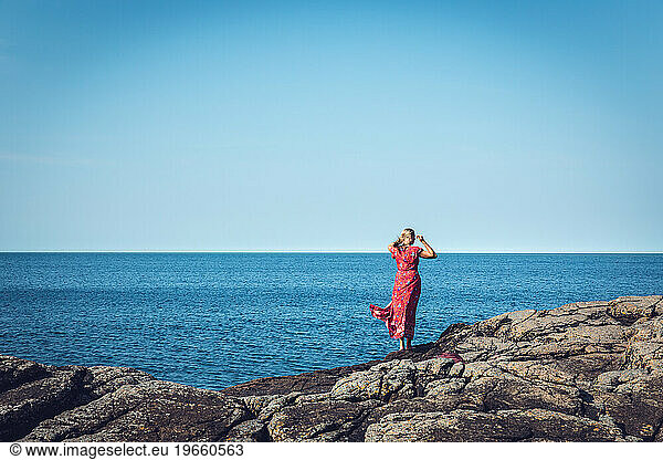 Silhouette Of Woman In Red At The Ocean Sunny Day In Scandinavia