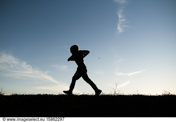 Silhouetted Boy Running on Hill in Waco Texas