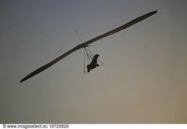 Silhoutette of hang glider off California coast in La Jolla.