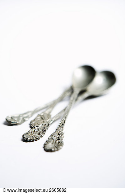 Silver spoon against white background