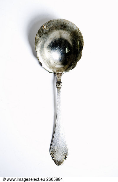 Silver spoon against white background