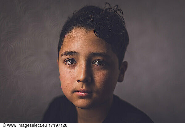 Simple portrait of a boy looking serious.