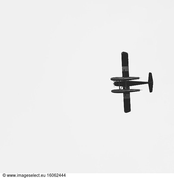 Single engine bush plane flying across open sky (plane is a DeHavilland Beaver) Alaska USA