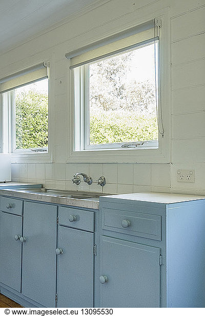 Sink by windows in room at home