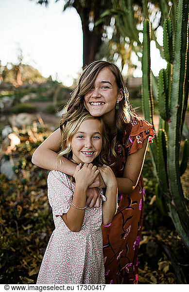 Sisters Embracing in Desert Garden in San Diego