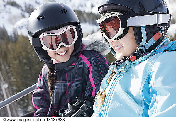 Sisters enjoying ski lift ride