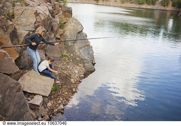 Sisters fishing in lake