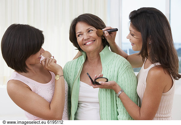 Sisters giving mother a makeover