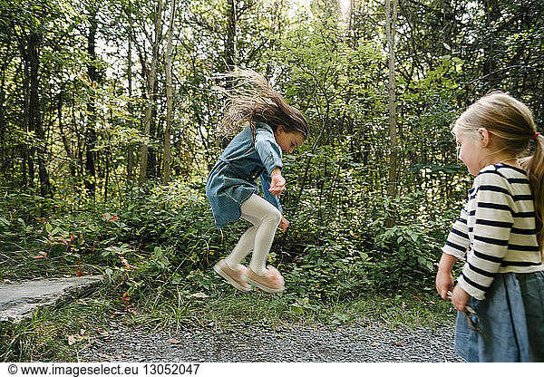 Sisters playing in forest