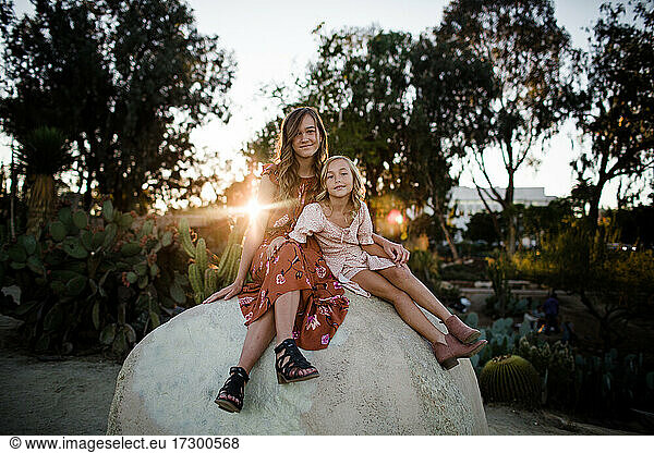 Sisters Posing on Giant Rock in Desert Garden in San Diego