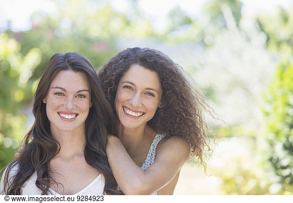 Sisters smiling together outdoors