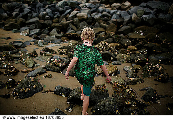 Six Year Old Boy Climbing on Rocks in Coronado Bay