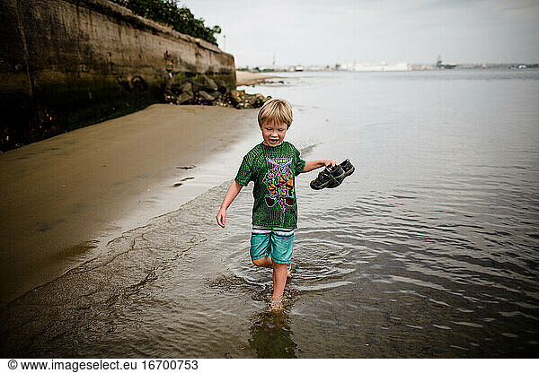 Six Year Old Boy Holding Sandals Running in Coronado Bay