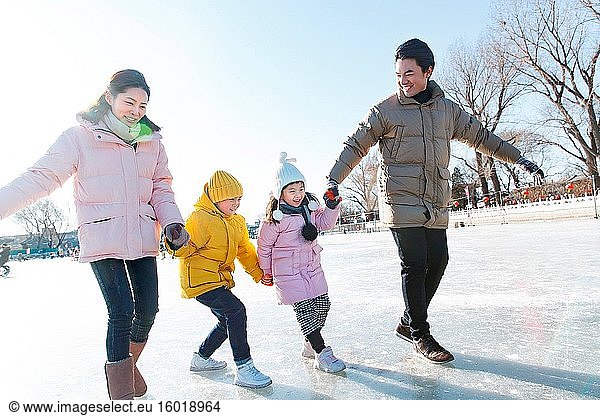 Skating glückliche Familie Hand in Hand