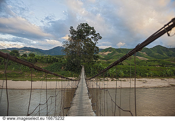 sketchy suspension footbridge in rural area of Vietnam