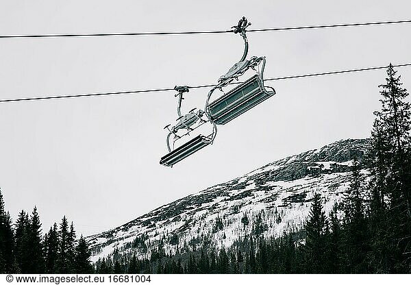 ski chair lift with snow covered mountains in the background in Sweden