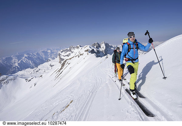 Ski mountaineers climbing on snowy mountain  Tyrol  Austria