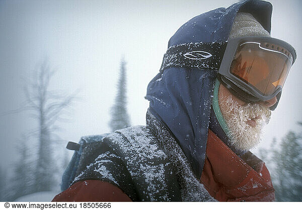 Ski patrolman during snowstorm  Montana  USA.