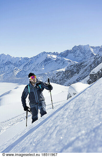 Skier climbing the ski slope  Bavaria  Germany  Europe