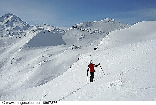 Skier looking at snowy terrain  Trois Vallees ski resort  Haute Savoie  France  Europe