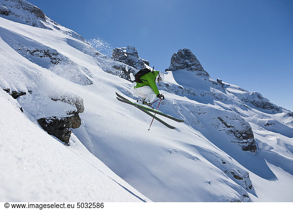 Skier skiing down through slope