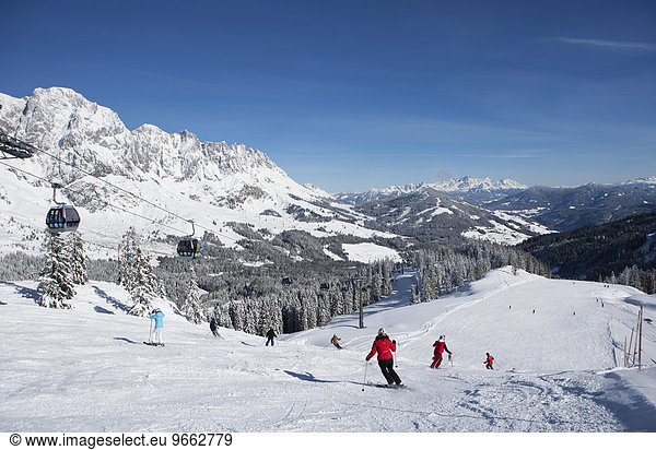 Skiers on ski slope in front of mountain scenery Hochkönig Amade skiing area Mühlbach Salzburg State Austria Europe