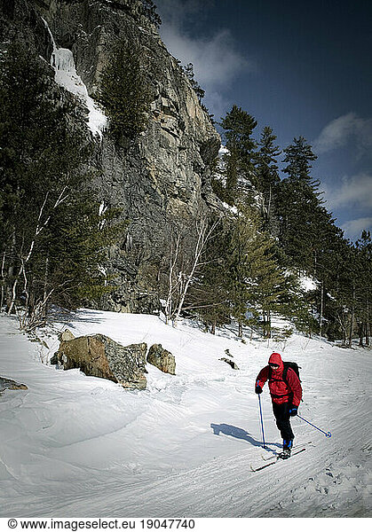 Skiing on Moosehead Lake below the lower cliffs of Mount Kineo  Maine.
