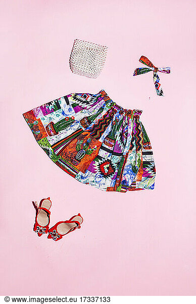 Skirt and fashion accessories on pink background