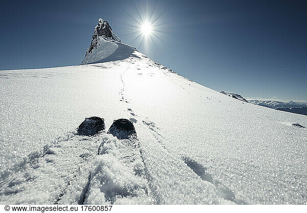 Skis next to hare tracks along snowcapped peak in Rofan Mountains