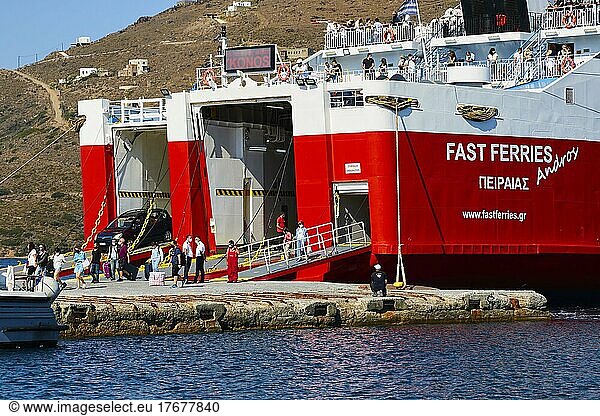 Sky blue  ferry unloads  red and white ferry  stern  passengers on deck  Fast Ferries  cloudless  sea blue  Gavrio  Andros Island  Cyclades  Greece  Europe