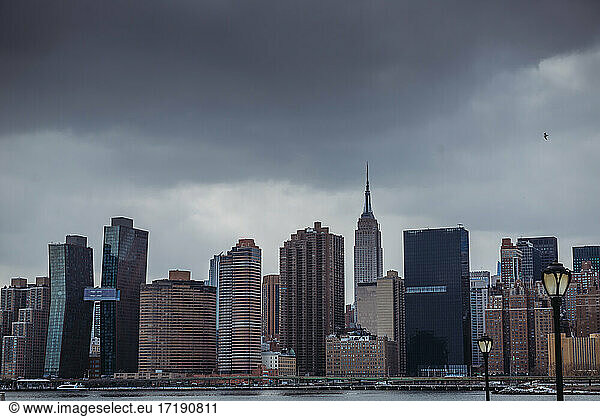 Skyline of New York City and Empire State Building on cloudy day