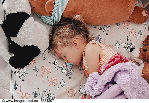 sleeping toddler with her blue binky
