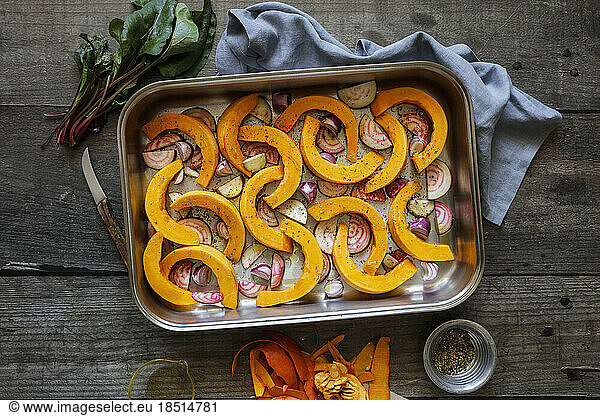 Sliced onions  pumpkins and common beets on baking sheet