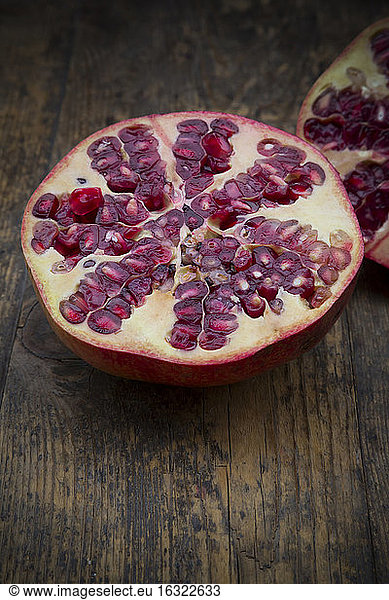 Sliced pomegranate on wood
