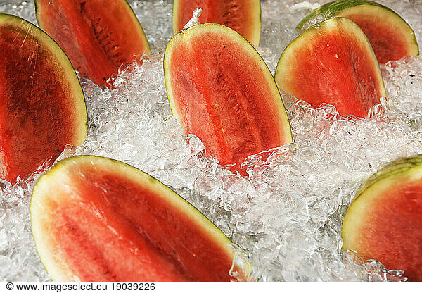 Sliced watermelon on ice.
