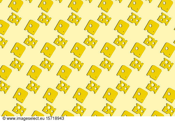 Slices of cheese pattern on yellow background